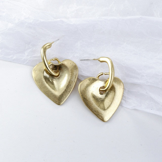Pearl and alloy geometric earrings close-up detail