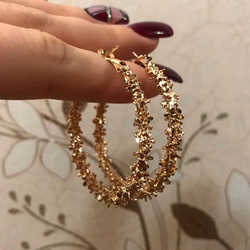 Pearl and gold hoop earrings, side angle view