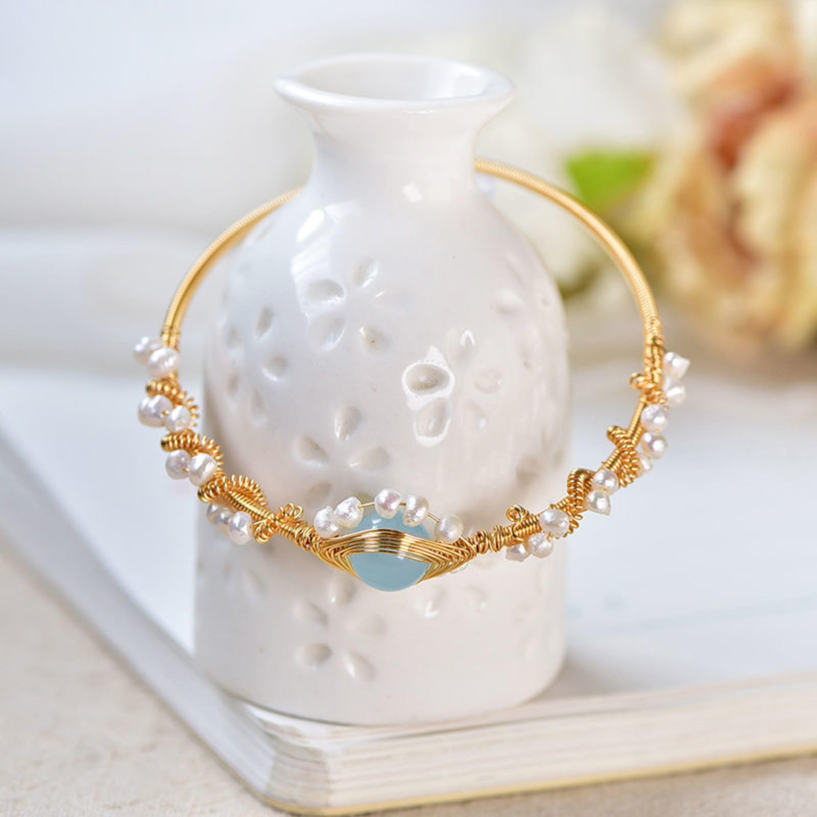 Gold-plated pearl bracelet, close-up of pearl and gold wire detail