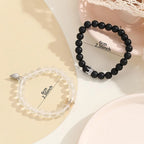 Crown charm bracelet set worn on wrist