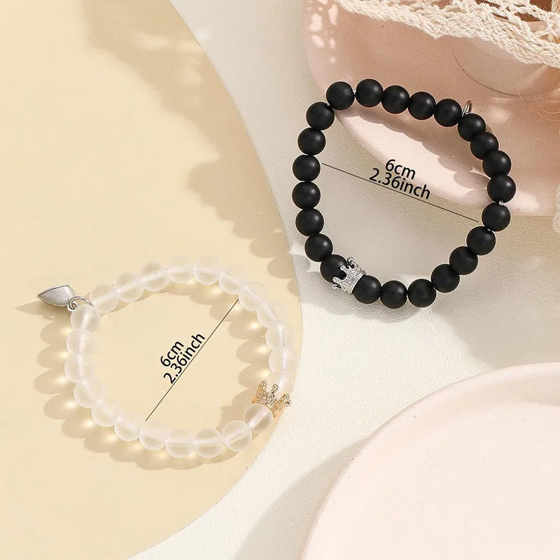 Crown charm bracelet set worn on wrist