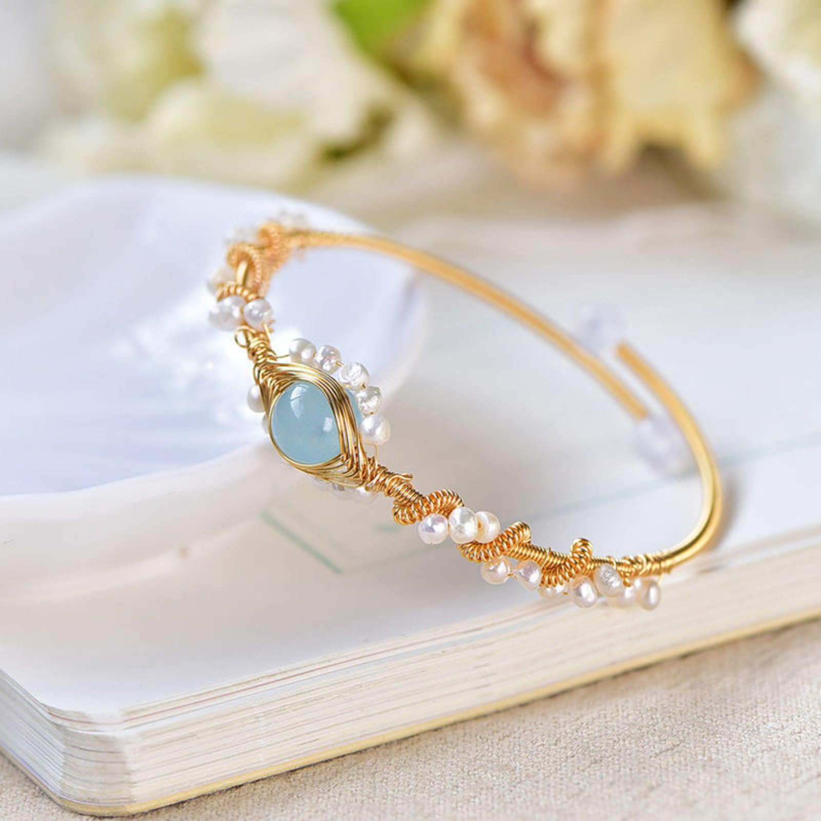Gold-plated pearl bracelet worn on wrist