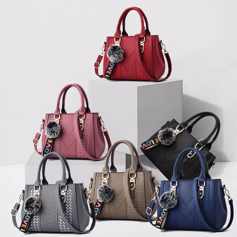 Leather embroidery messenger bag for women with hand strap, stylish ladies' handbag featuring intricate embroidery details.