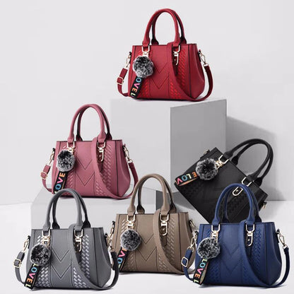 Leather embroidery messenger bag for women with hand strap, stylish ladies' handbag featuring intricate embroidery details.