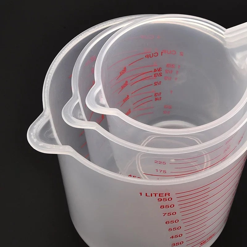Set of three Prime Deal Zone plastic baking liquid measuring cups with PVC scale for kitchen baking and measuring liquids.