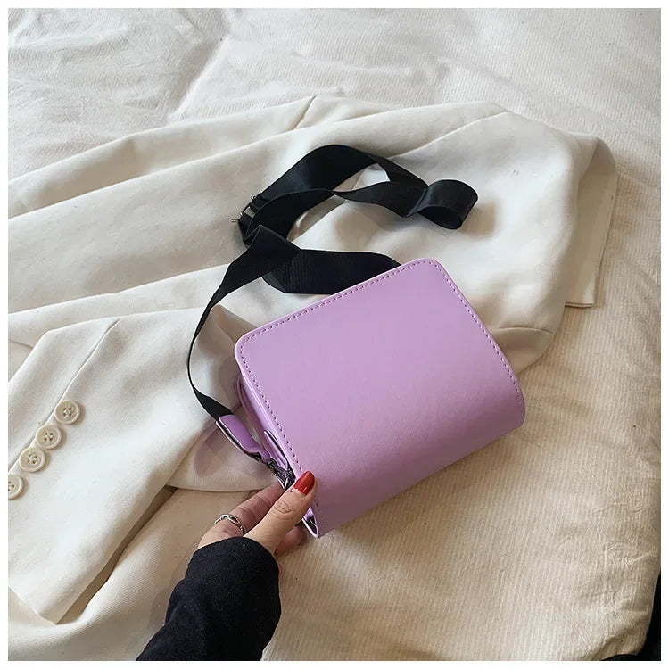 Small PU leather crossbody bag for women, featuring a shoulder strap and compact design ideal for travel and everyday use.