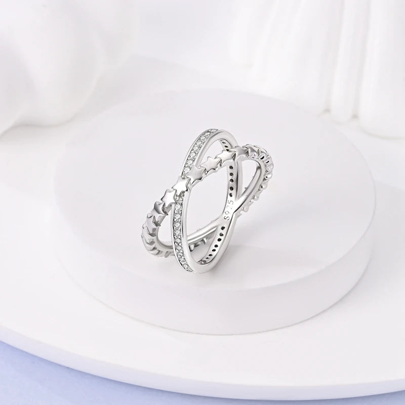 Silver zircon X ring worn on hand