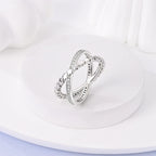 Silver zircon X ring worn on hand