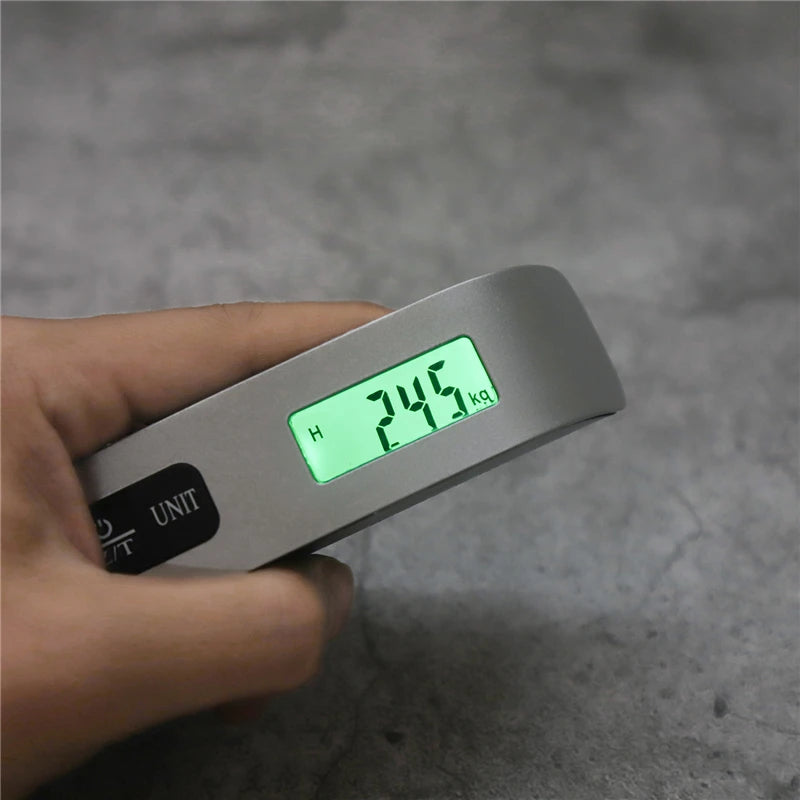 Digital portable luggage scale with LCD display showing 50kg weight, ideal for travel and baggage weight measurement.