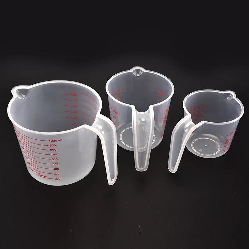 Set of three Prime Deal Zone plastic measuring cups with PVC scale, 250ml, 500ml, and 1000ml, used for baking and cooking.