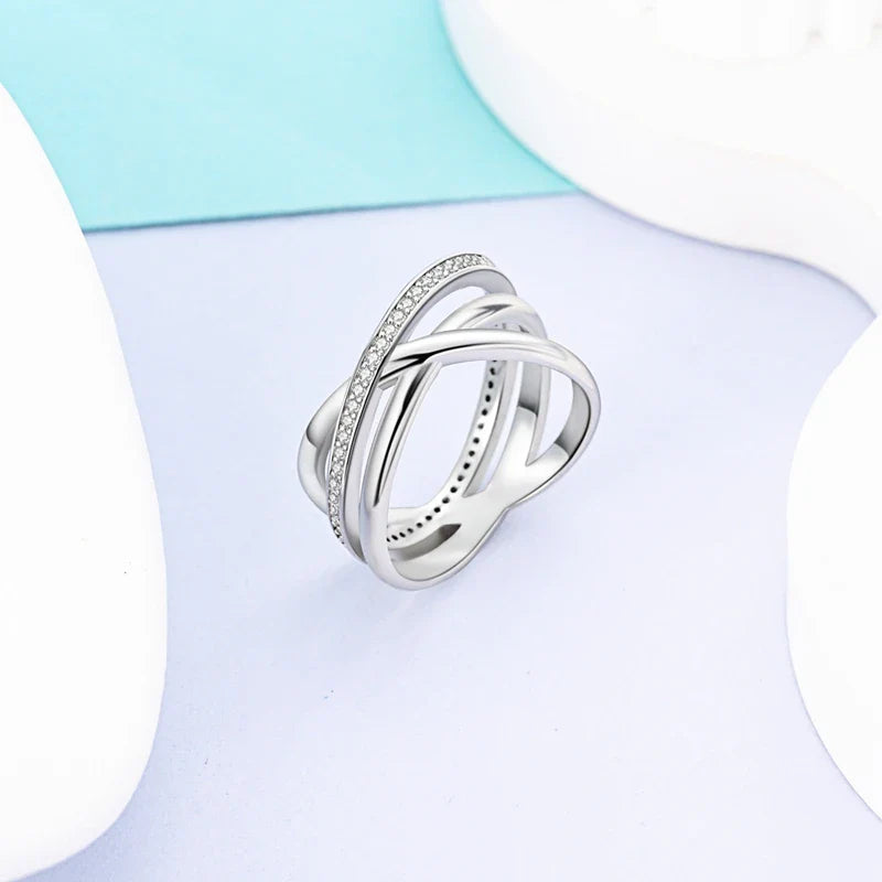 Silver X ring with zircon accent, side view