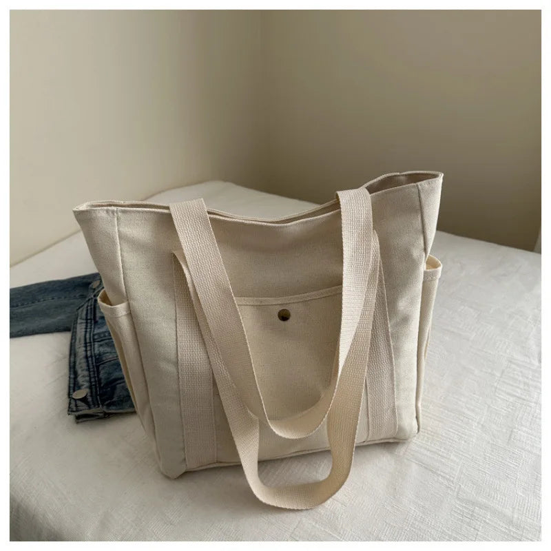 Large-capacity canvas shoulder bag by Prime Deal Zone, versatile for students' class and daily use, with a sturdy, stylish design.