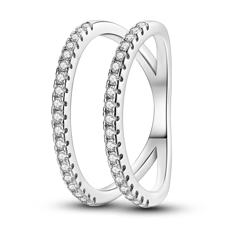 Silver zircon star ring worn on multiple fingers