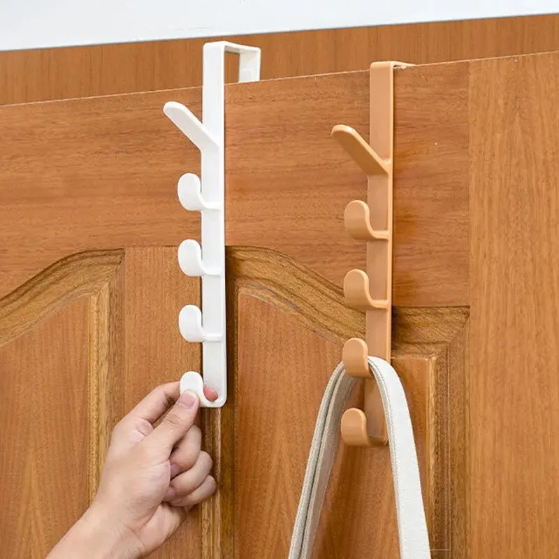 Plastic over-the-door clothes hanger rack with hooks for purses and bags, ideal for bedroom storage organization.