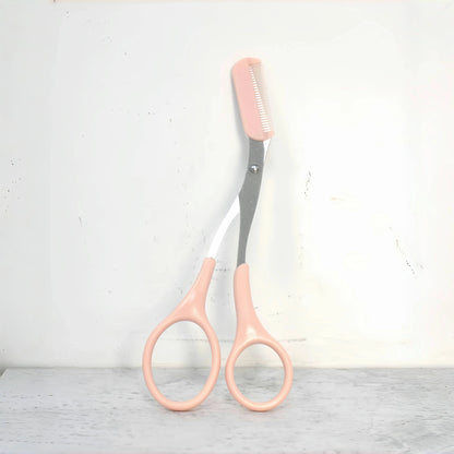 Pink stainless steel eyebrow trimming scissors with built-in comb from Prime Deal Zone for precise eyebrow grooming.