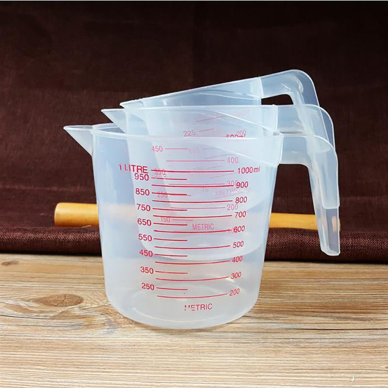Set of three Prime Deal Zone plastic baking measuring cups with PVC scale, 250ml, 500ml, and 1000ml volume beakers for kitchen baking.