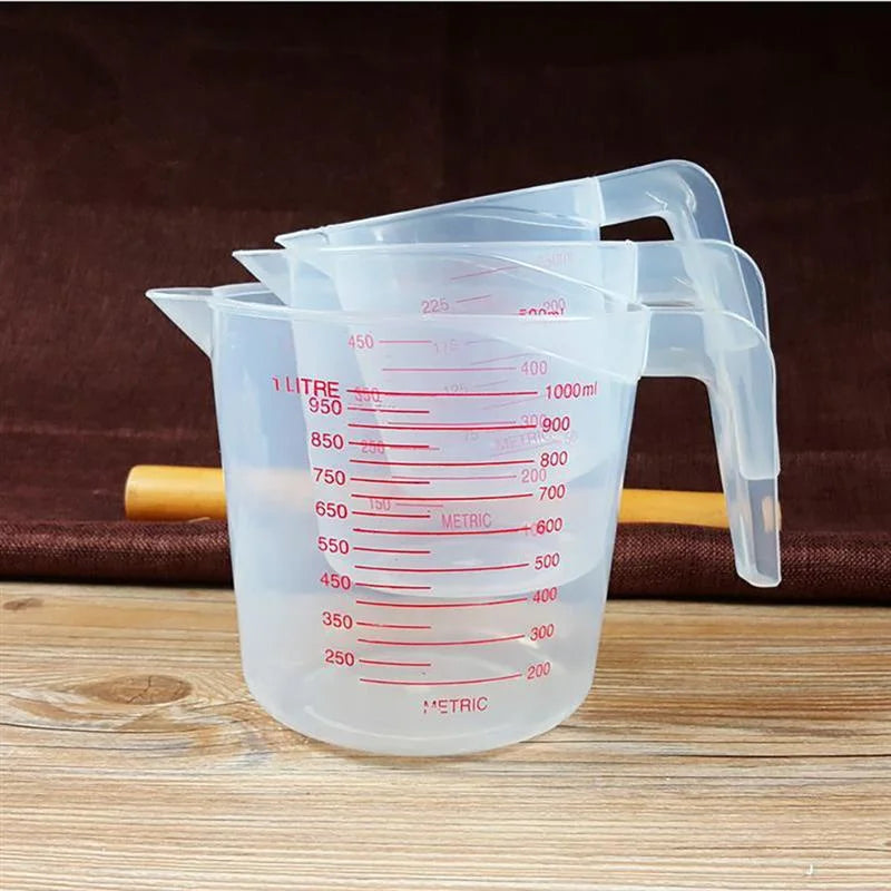 Set of three Prime Deal Zone plastic baking liquid measuring cups with PVC scale in 250ml, 500ml, and 1000ml sizes for kitchen use