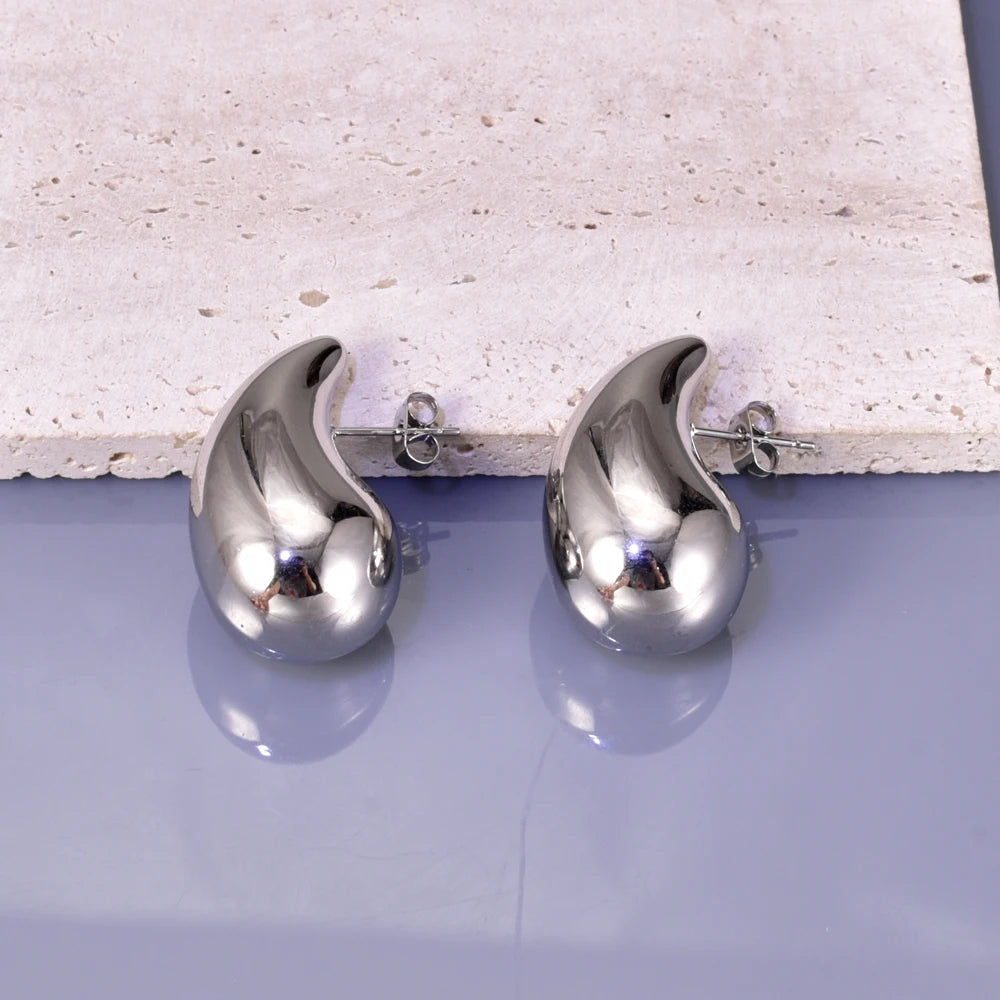Gold hollow drop earrings for women, close-up detail