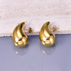 Gold hollow drop earrings for women, pair on display